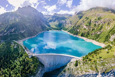 Image shows a dam in its natural surrounding