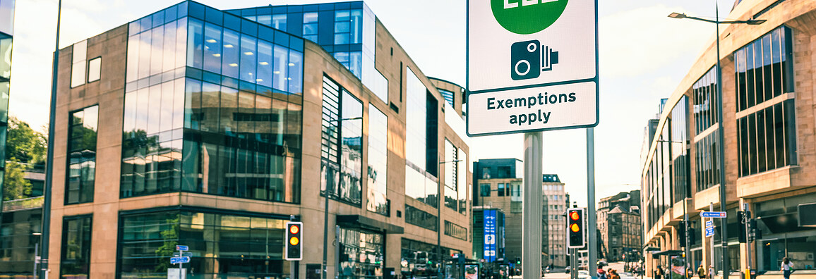 The image shows a LEZ sign in a city
